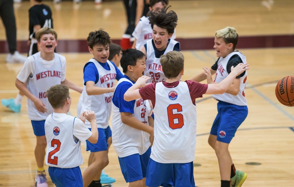 Westlake Hoops Select players mobbing each other in a post-game celebration.