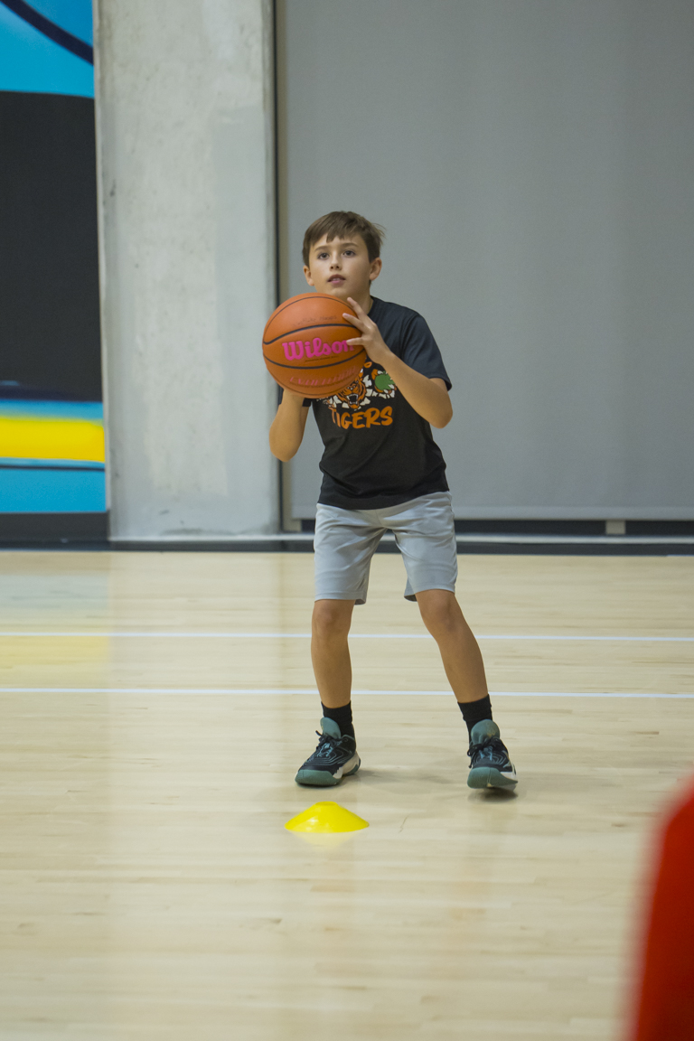 Young athlete in triple threat stance working on shooting form.