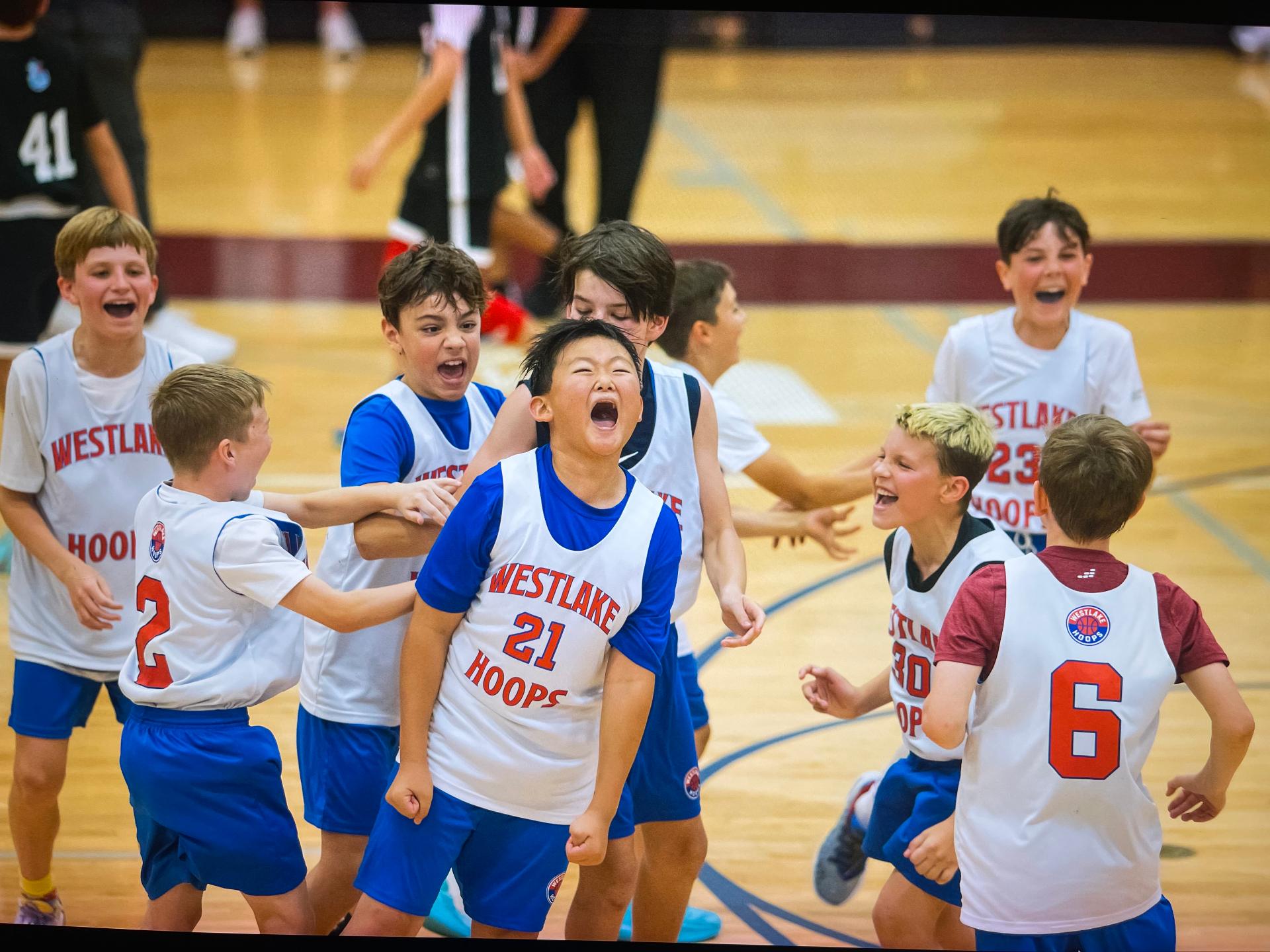 Westlake Hoops Select team erupting in celebration after a tournament win.
